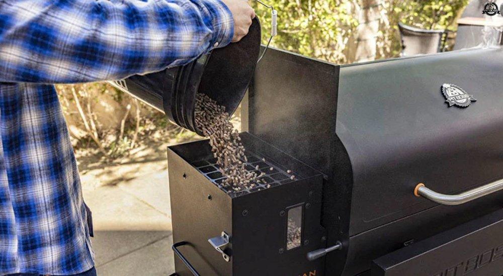 someone putting pellets into a pellet grill 